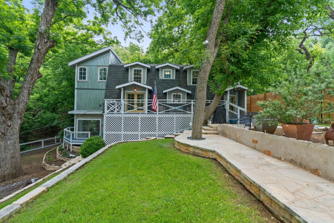 a front view of a house with yard and green space