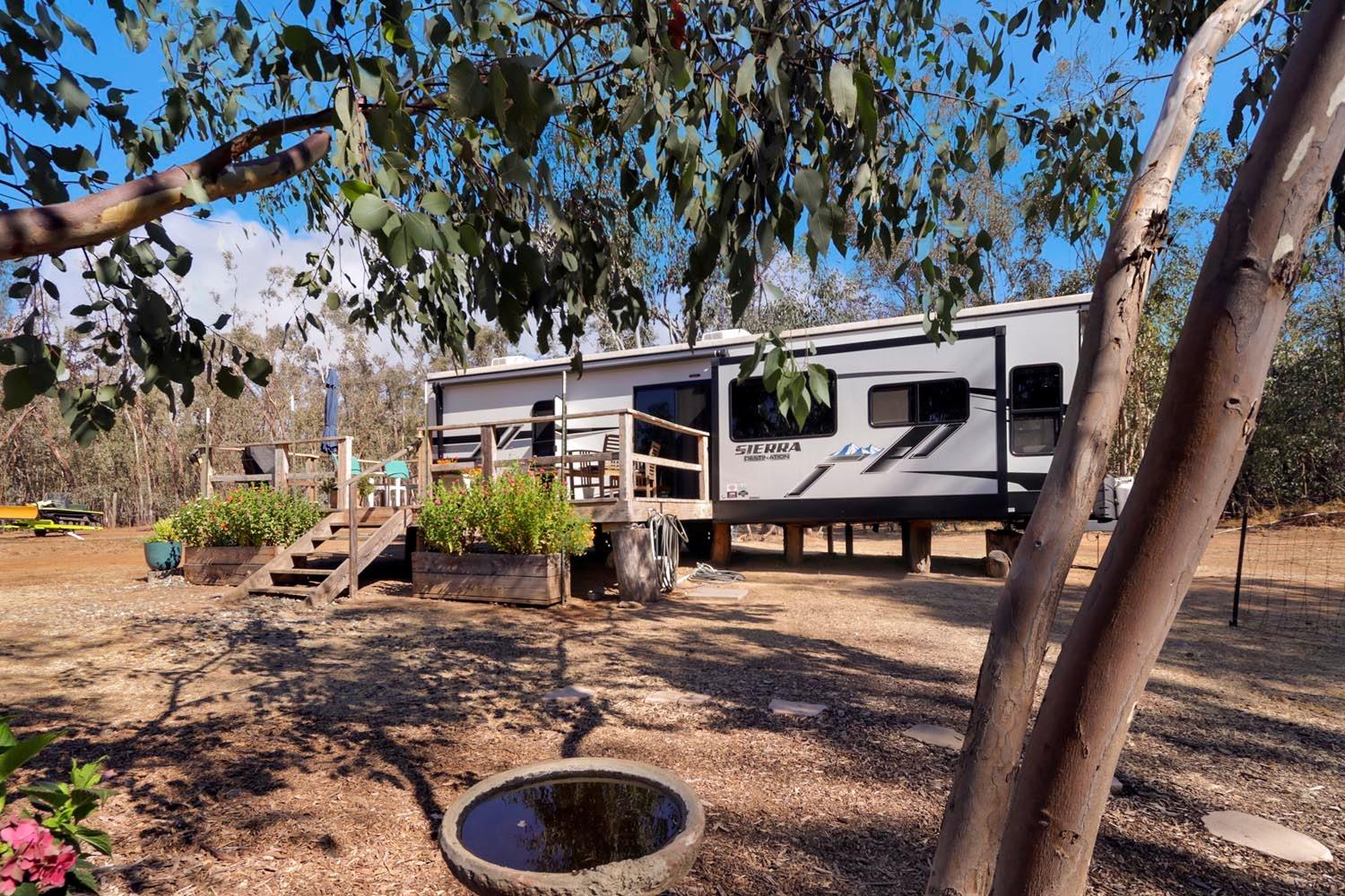 a view of a house with backyard porch and sitting area