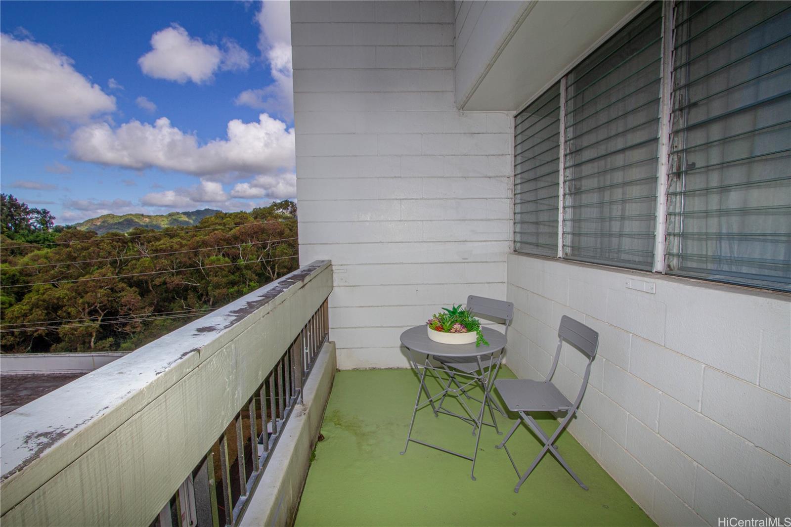 a balcony with table and chairs