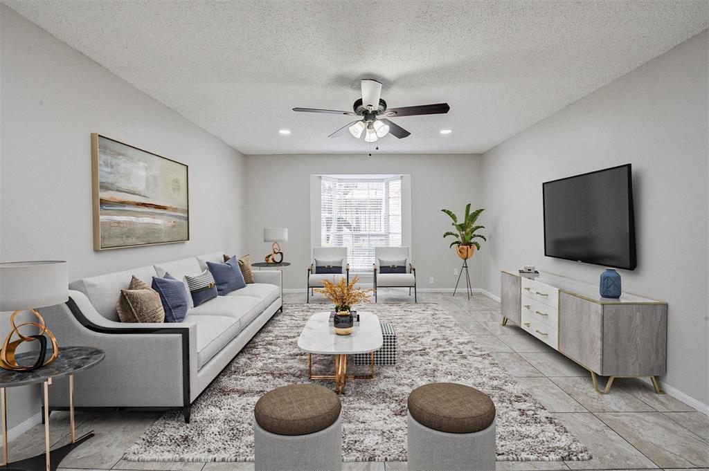 a living room with furniture a rug and a flat screen tv