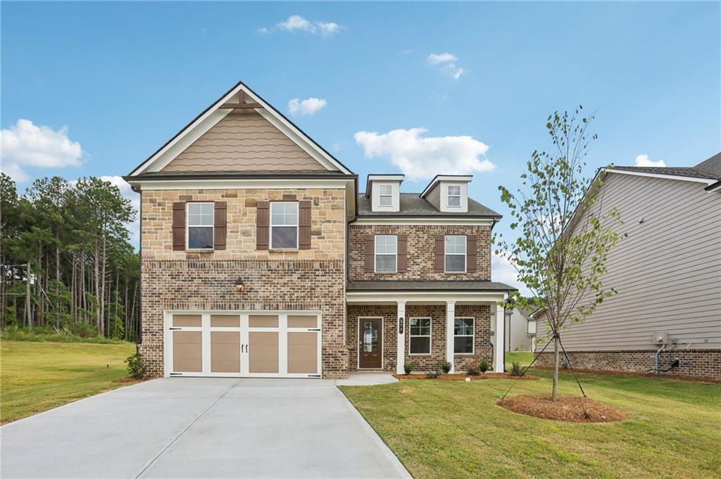 a front view of a house with a yard