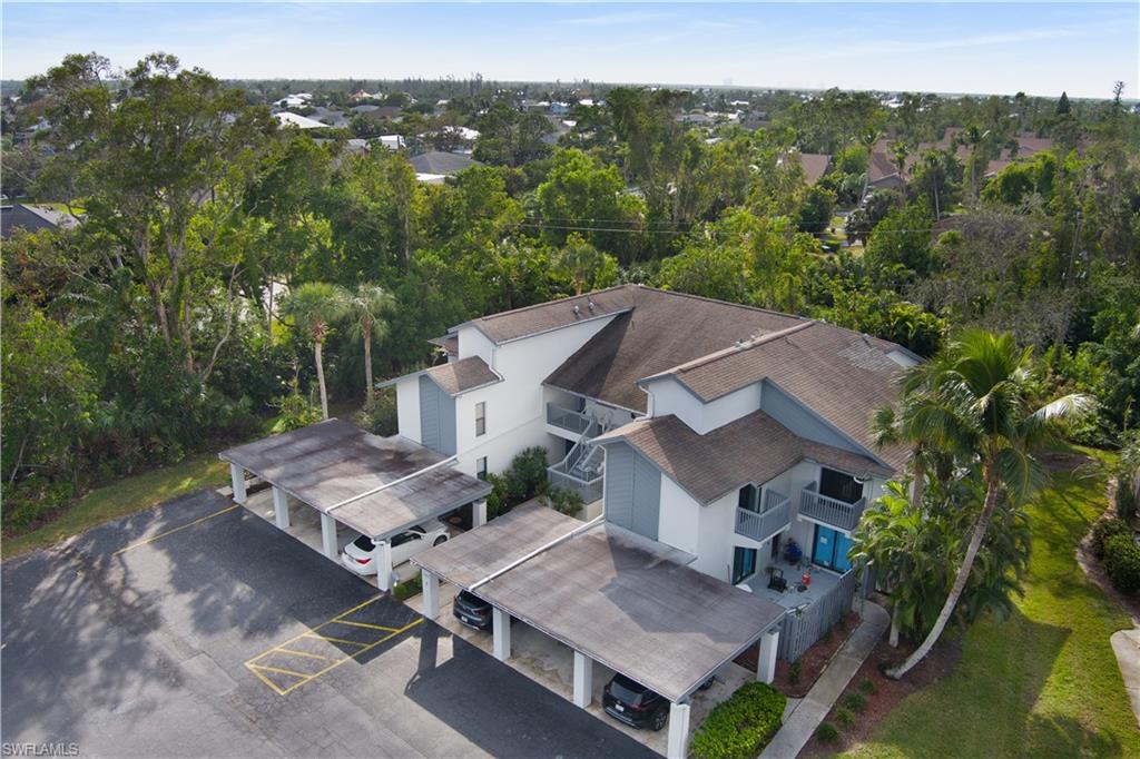 an aerial view of a house with pool table and chairs