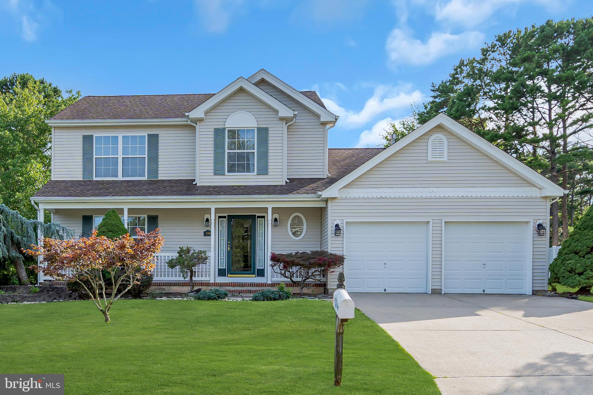 a front view of a house with a yard garage and outdoor seating