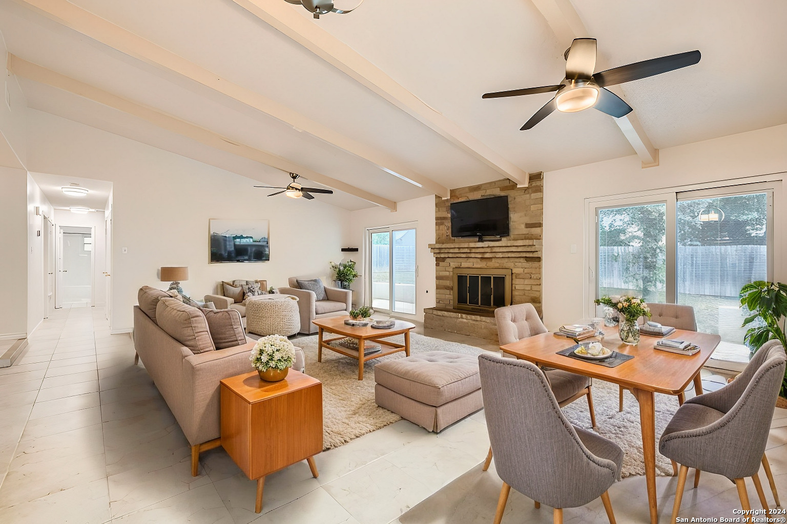 a living room with fireplace furniture and a flat screen tv