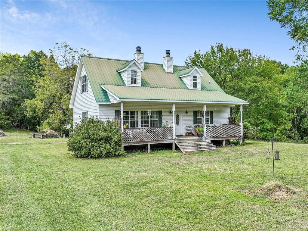 a front view of a house with a garden and porch