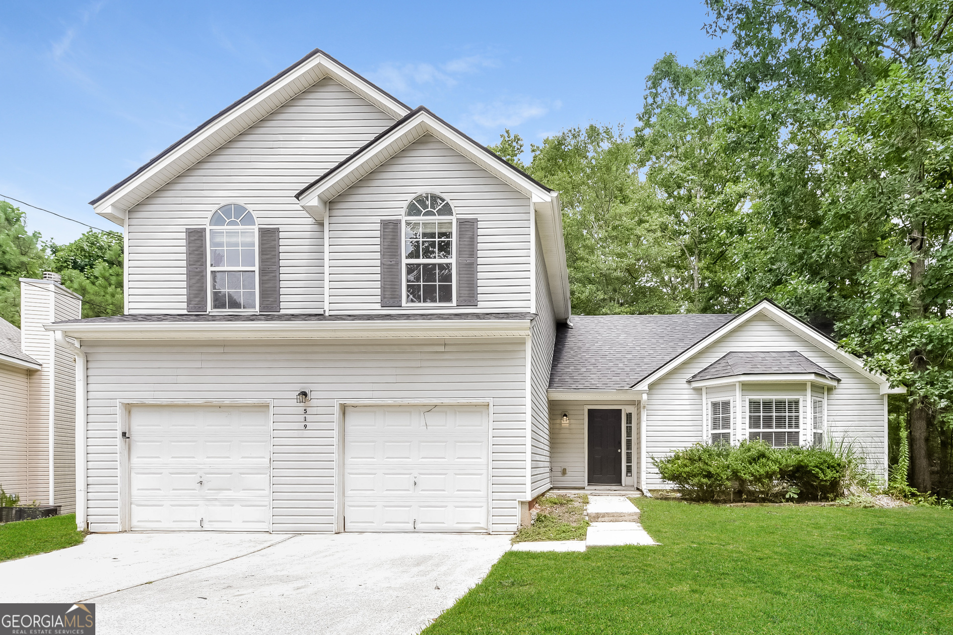 a front view of a house with a yard and garage