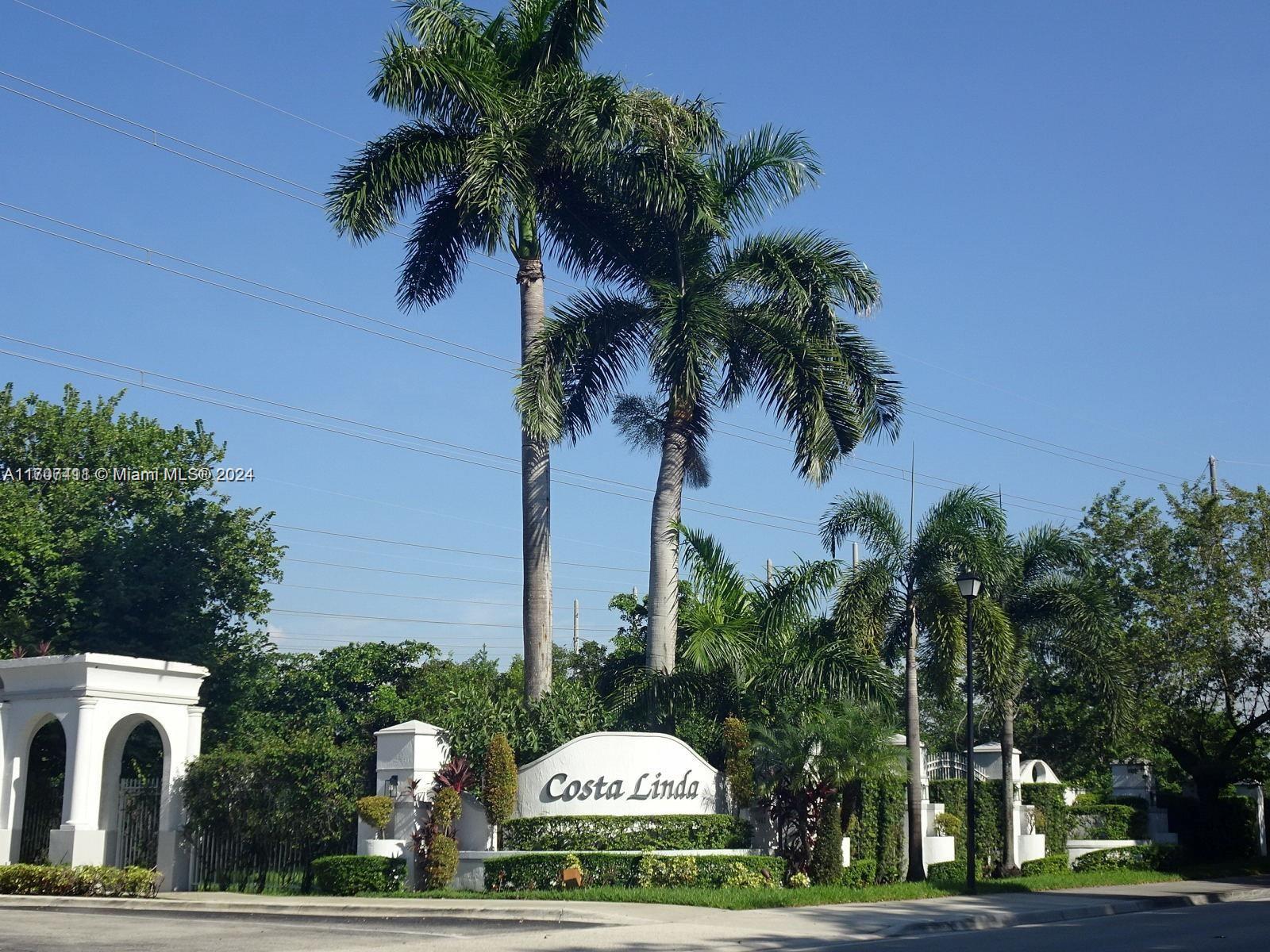 a sign board with palm trees