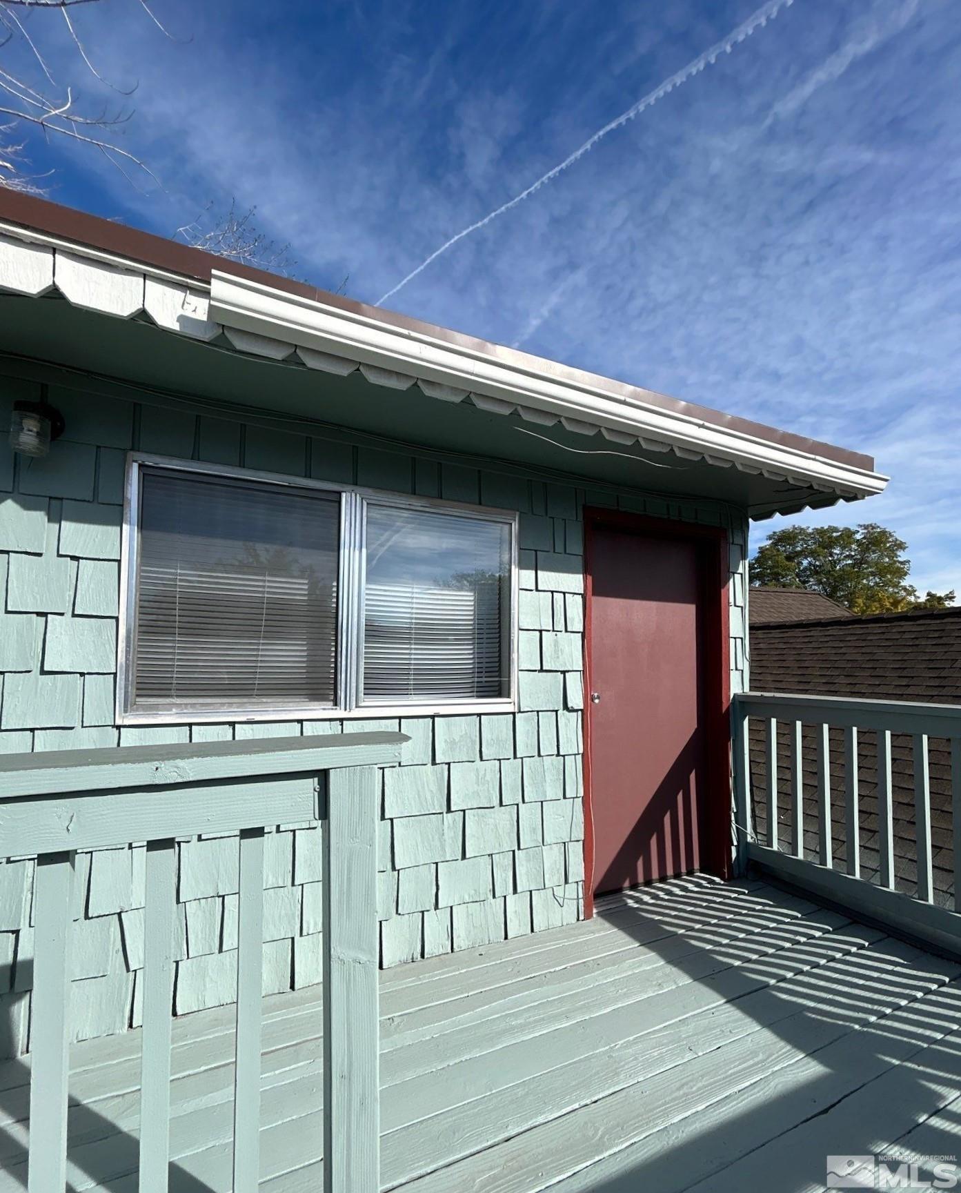 a view of backyard with deck and wooden floor