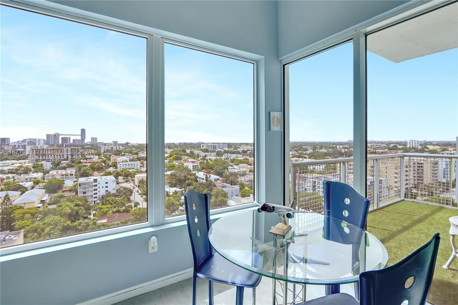 a view of a city from a dining room with a table or chairs