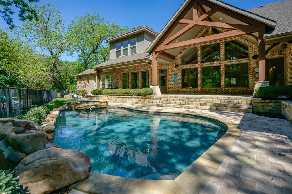 a view of a house with backyard porch and sitting area