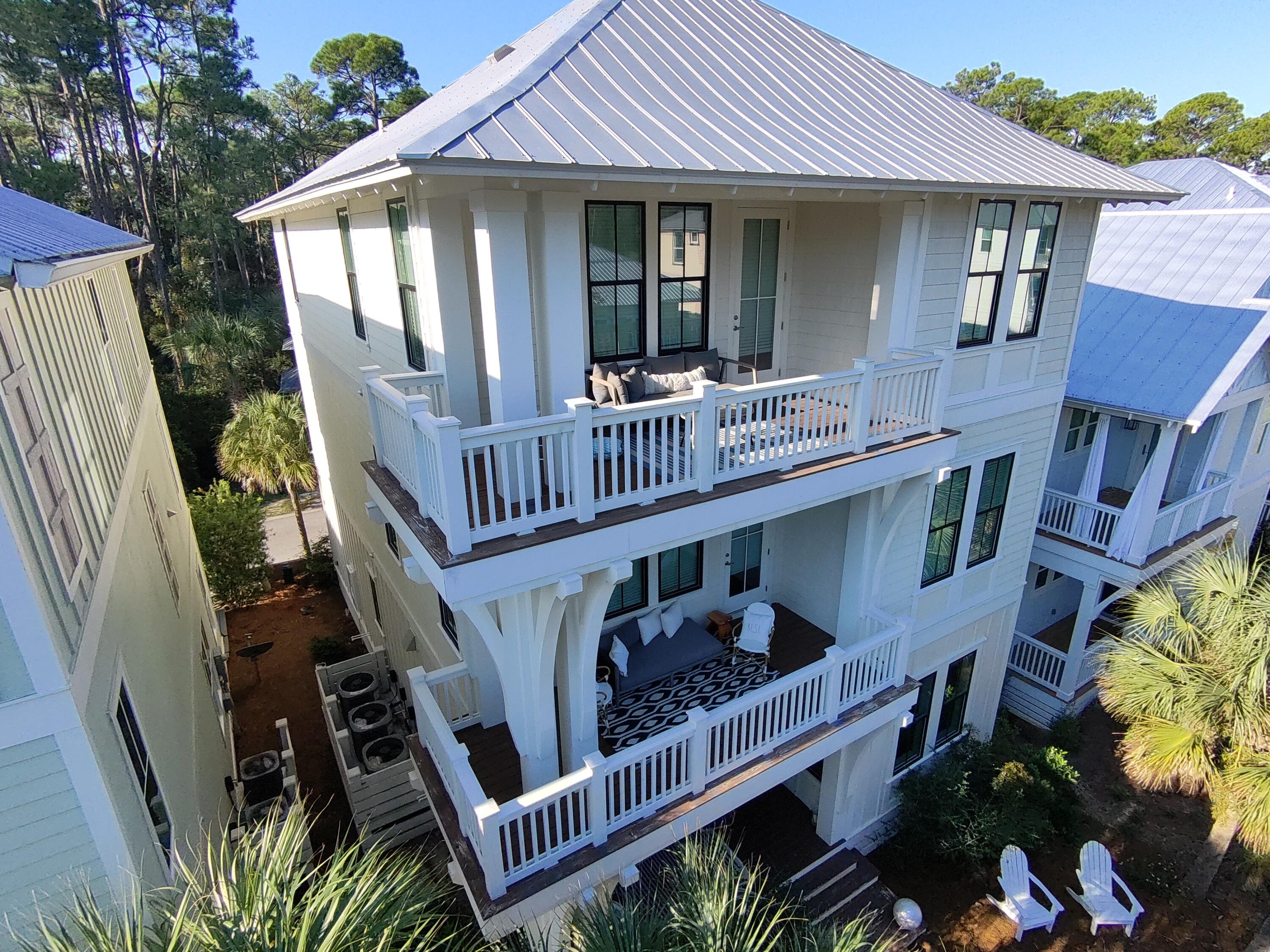 a view of a house with wooden deck and furniture