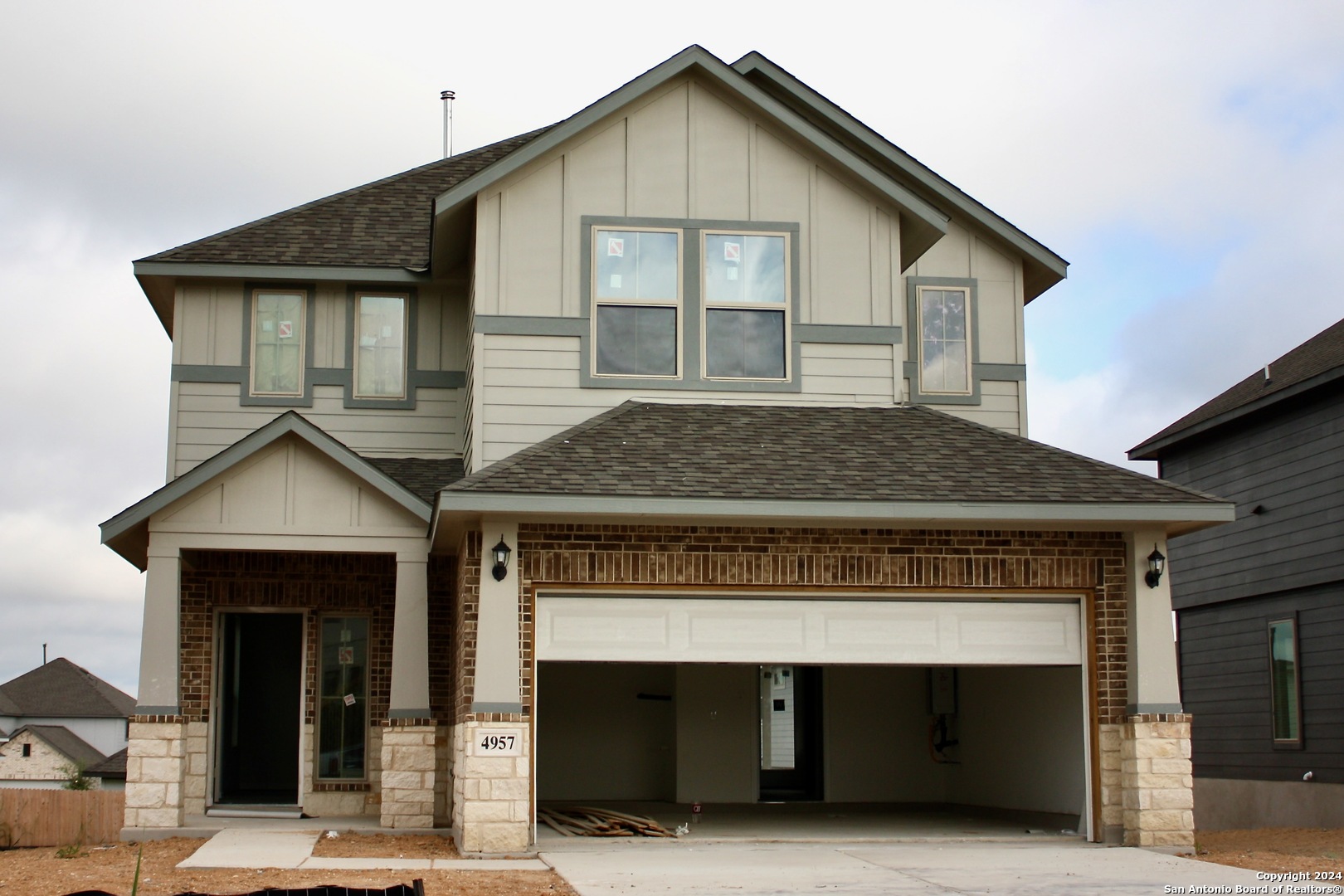 a front view of a house with entrance gate