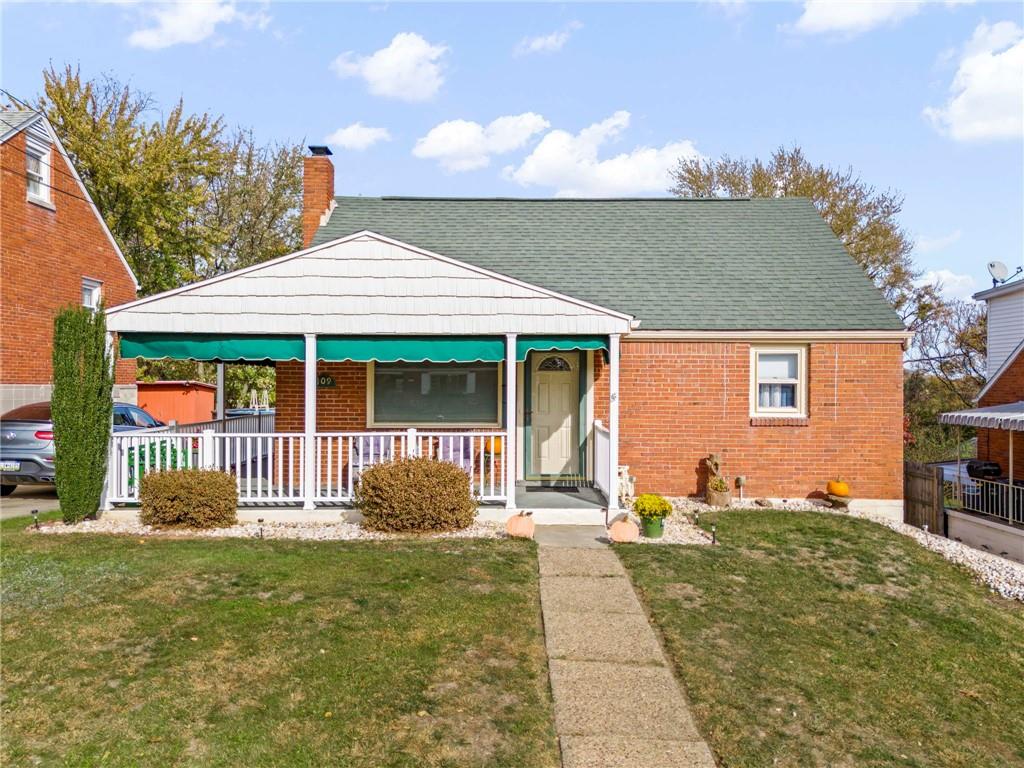 a front view of a house with a garden and porch