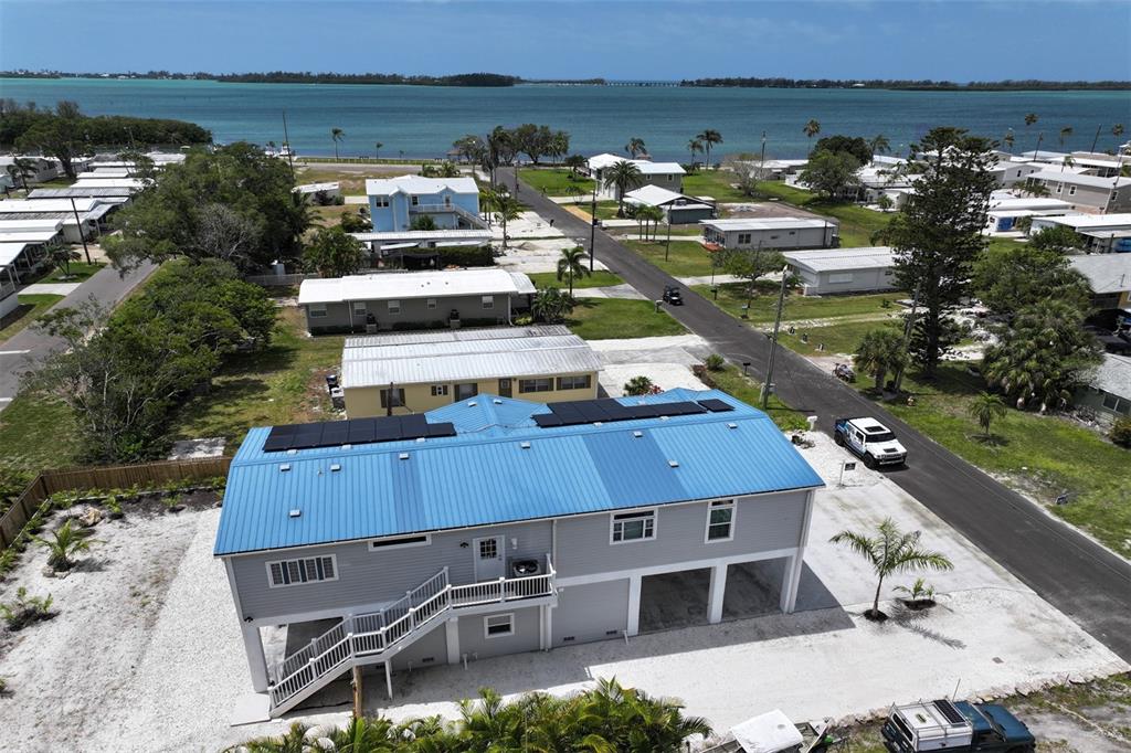 an aerial view of a house with lake view