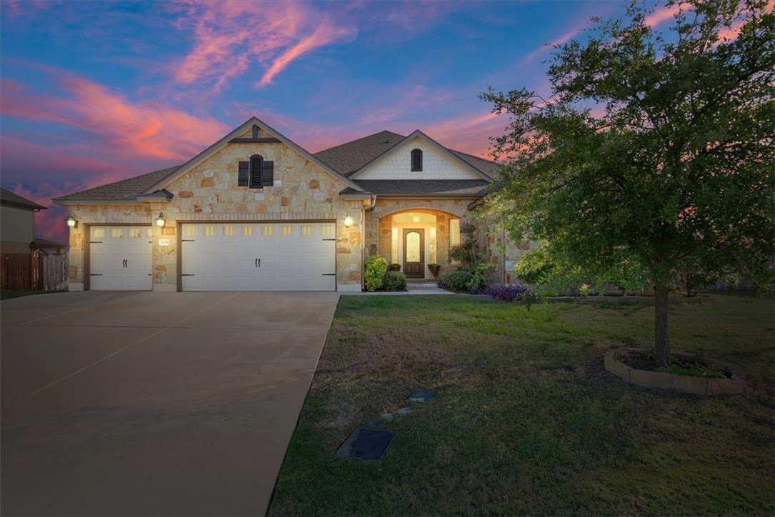 a front view of a house with a yard and garage