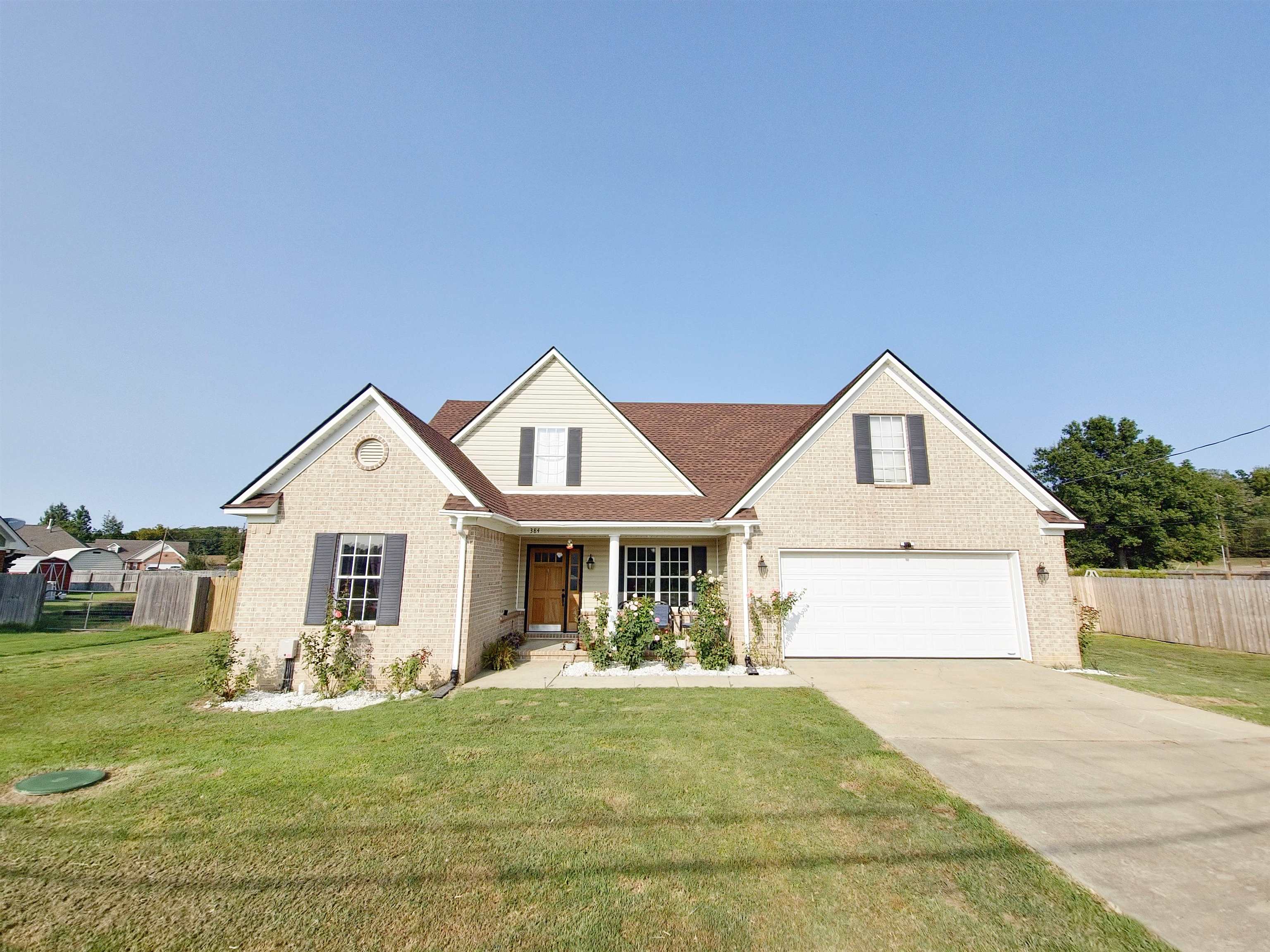 Front facade featuring a garage and a front lawn