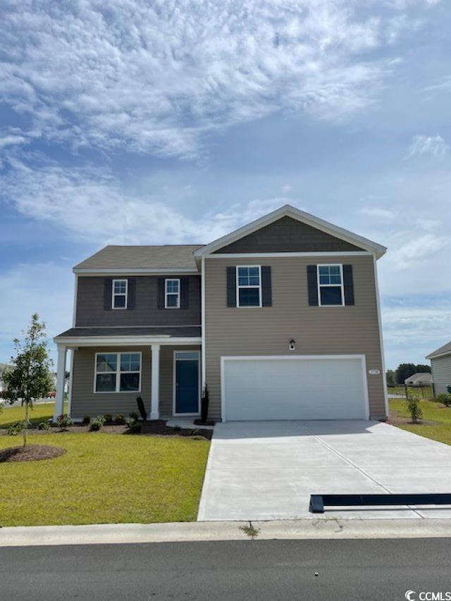 View of front facade featuring a front yard and a