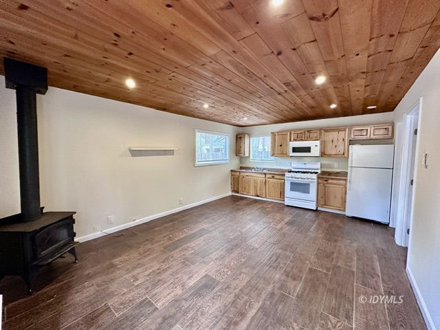 a view of kitchen with refrigerator microwave and stove top oven