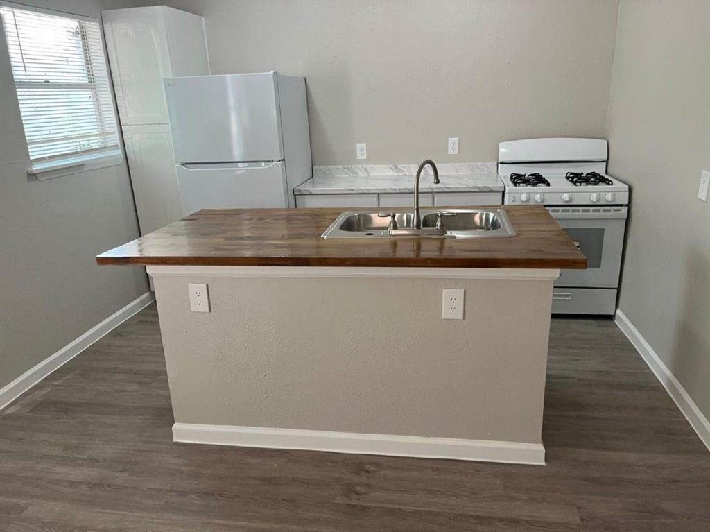 a view of kitchen with wooden floor