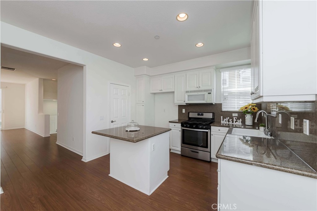 a kitchen that has a sink and a stove in it