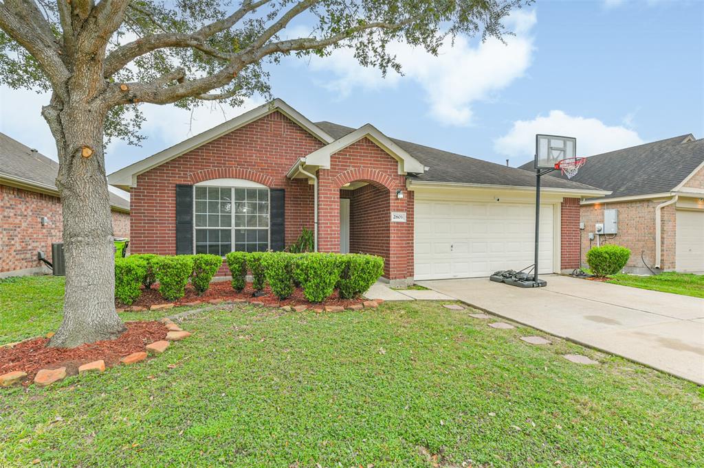 A charming brick exterior framed by manicured landscaping welcomes you home with timeless curb appeal.