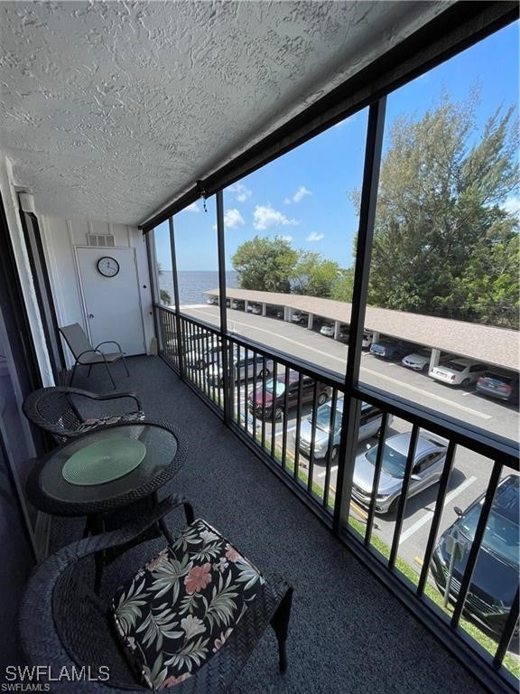 a room with furniture and a floor to ceiling window