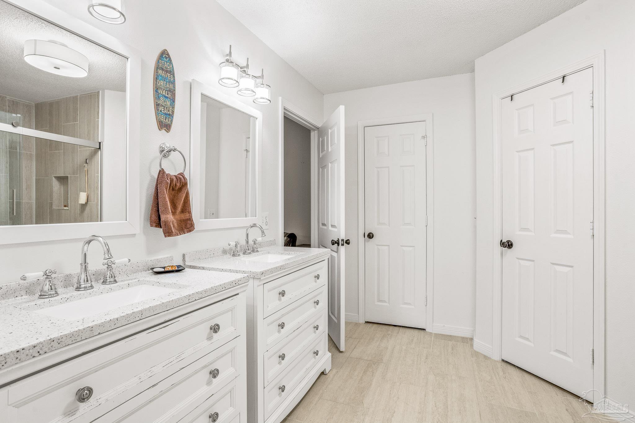 a bathroom with a double vanity sink and a mirror