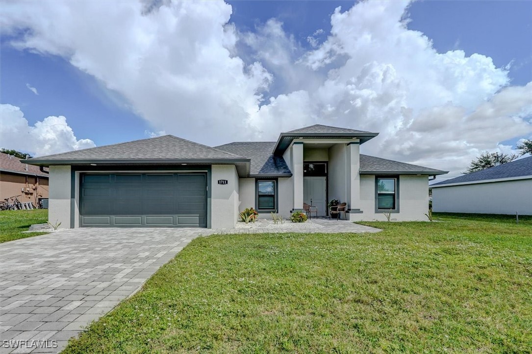 a front view of a house with a yard and garage