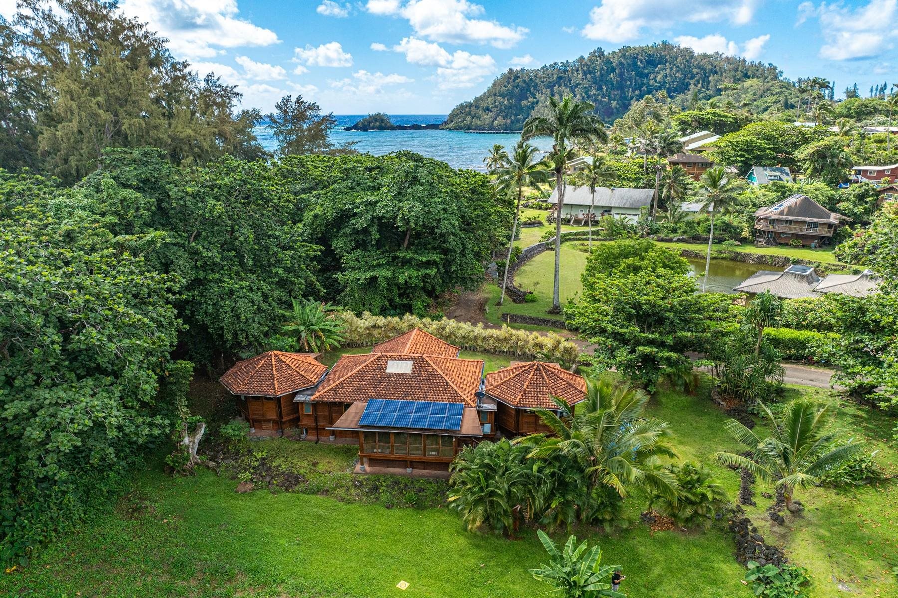 an aerial view of a house with swimming pool a yard and a fountain