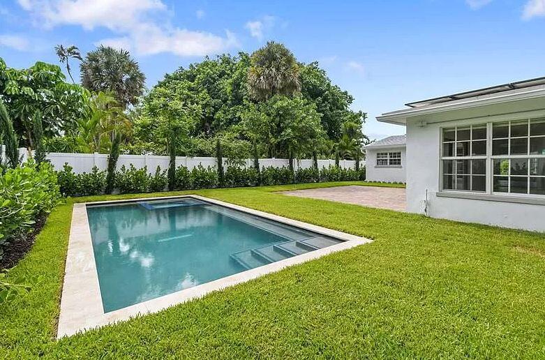 a view of a backyard with a small pool