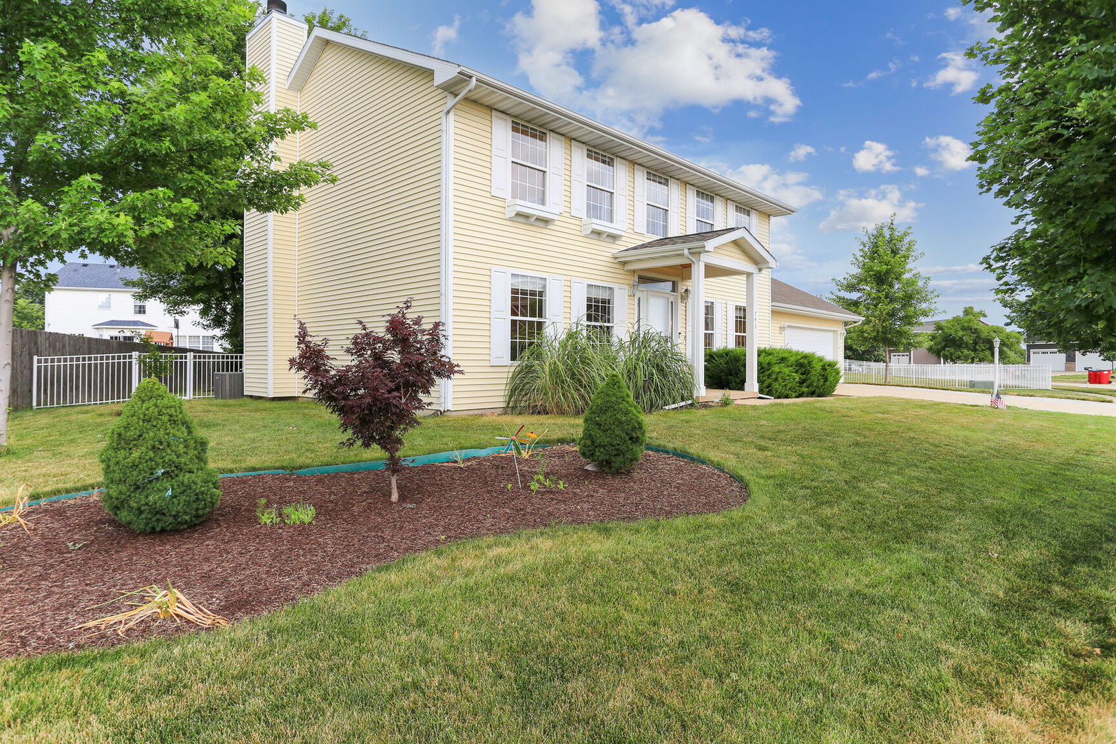 a view of a house with a yard and a garden