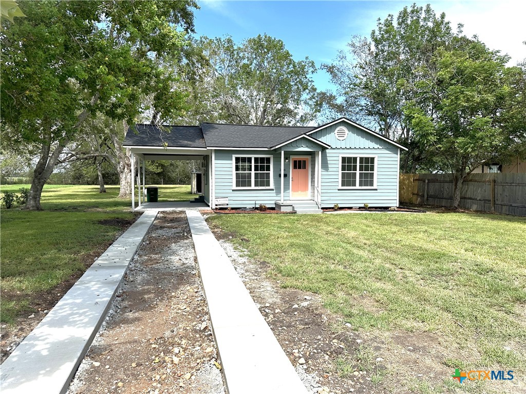 a front view of house with yard and green space