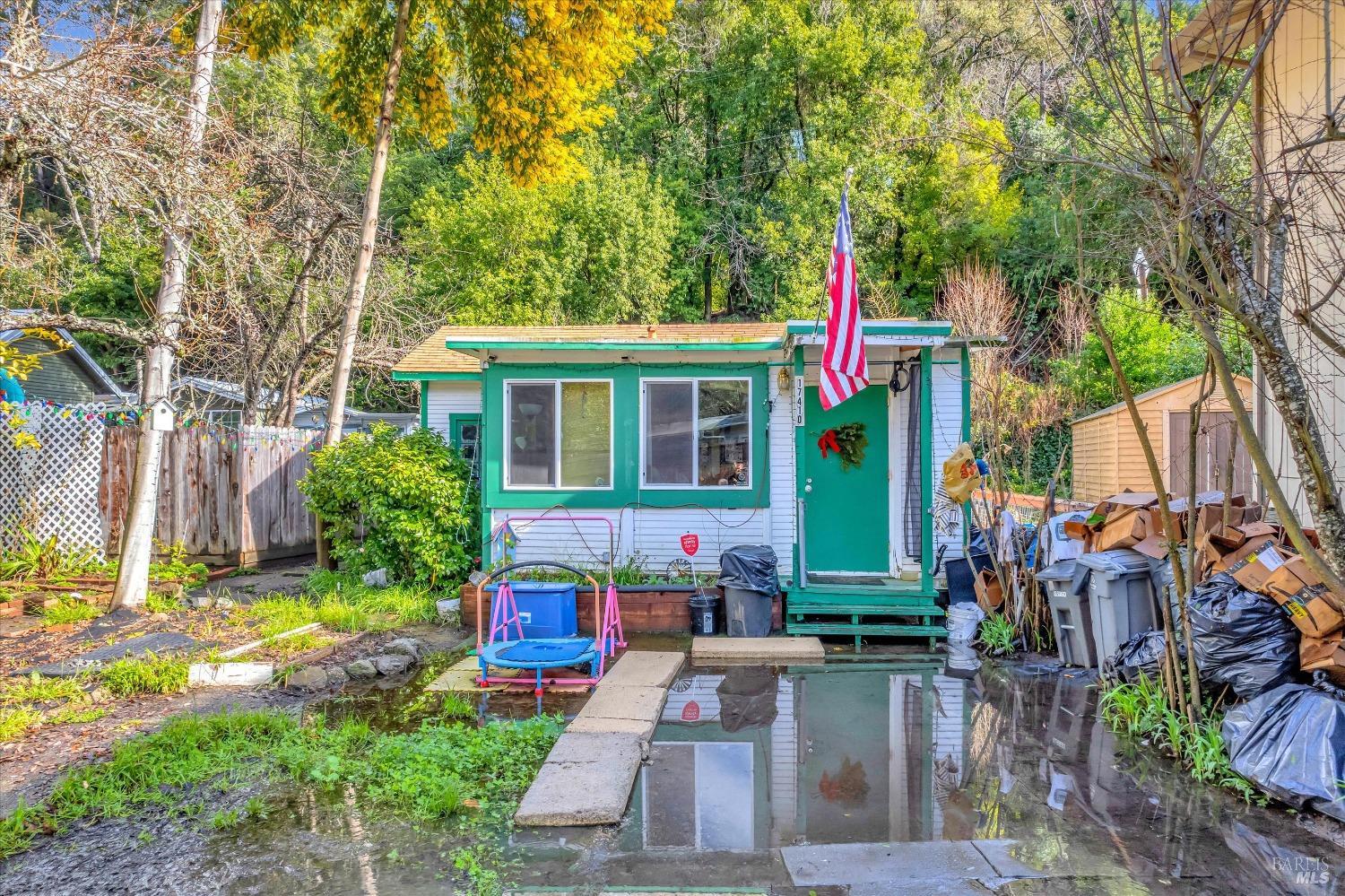 a front view of a house with a yard and potted plants