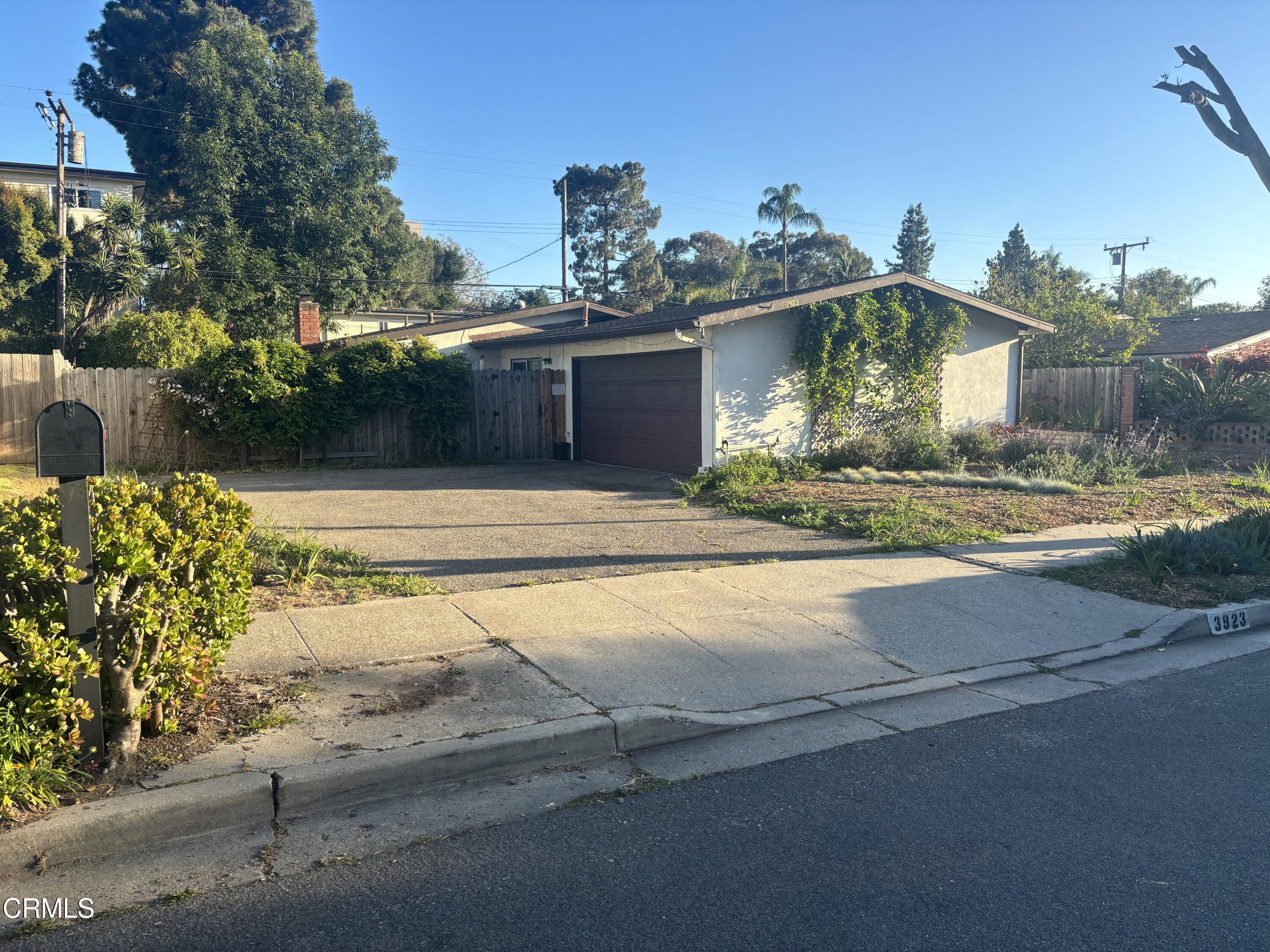 a front view of a house with a yard and a garage