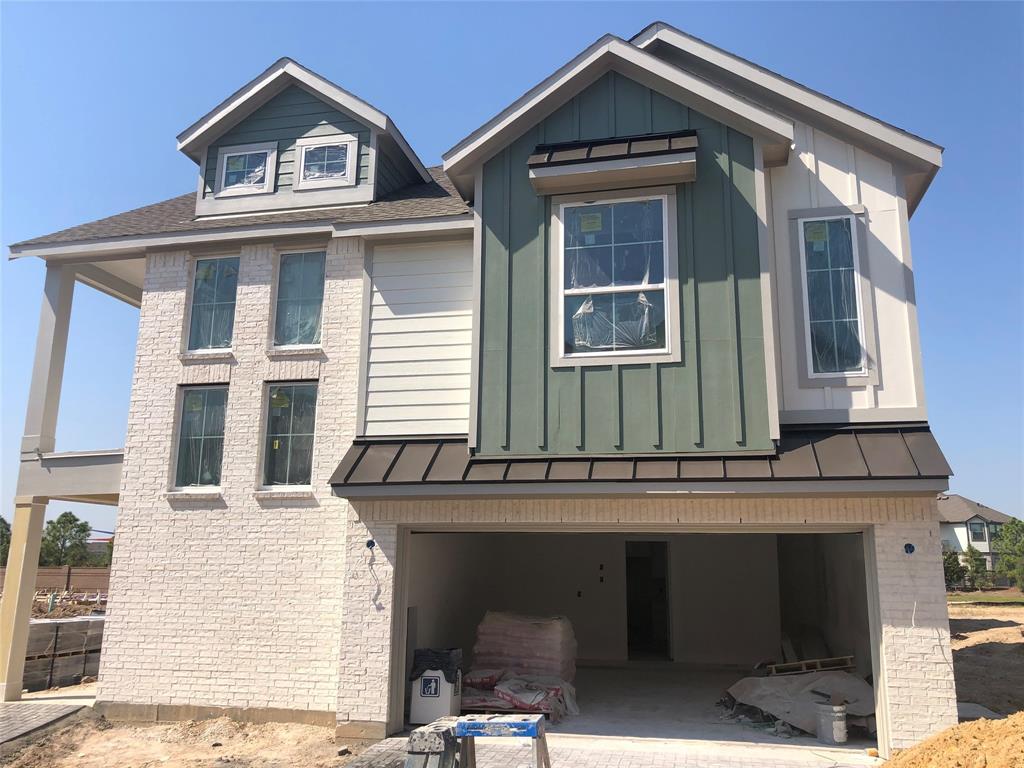 a front view of a house with a garage and balcony