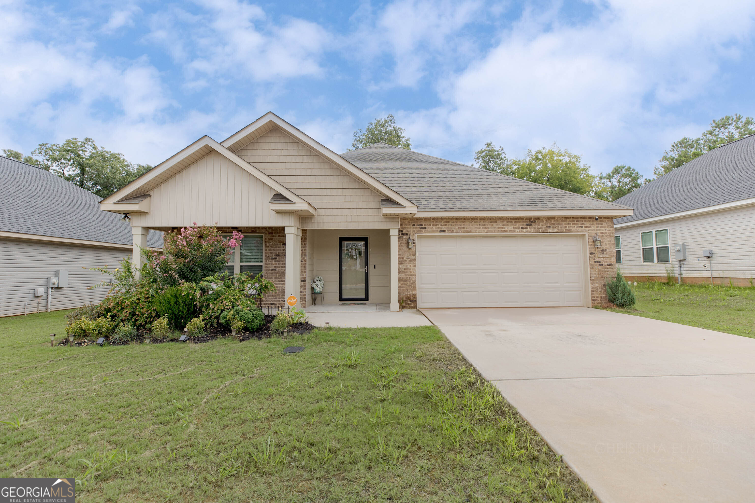 a front view of a house with a yard and garage