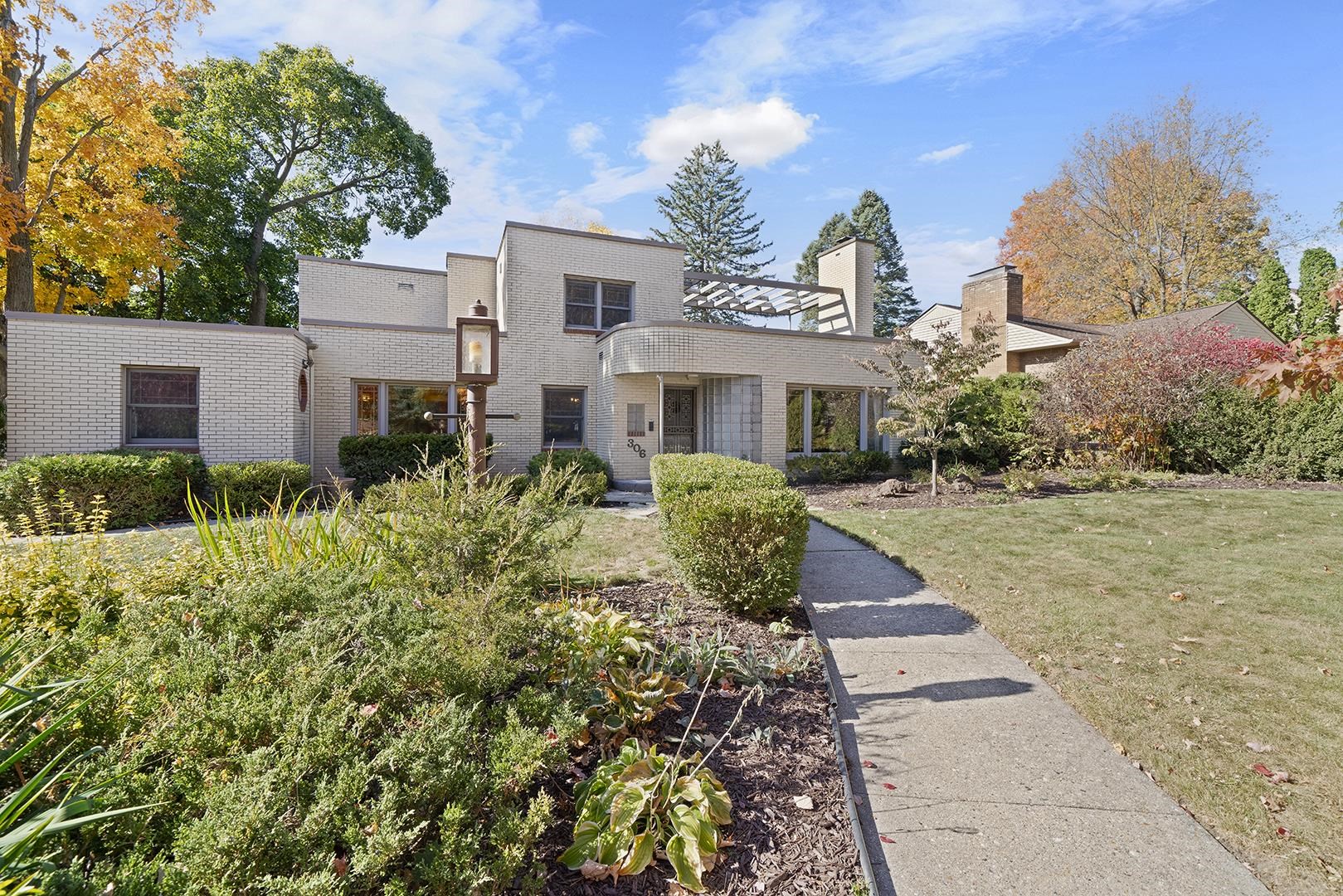 a front view of a house with a yard and trees