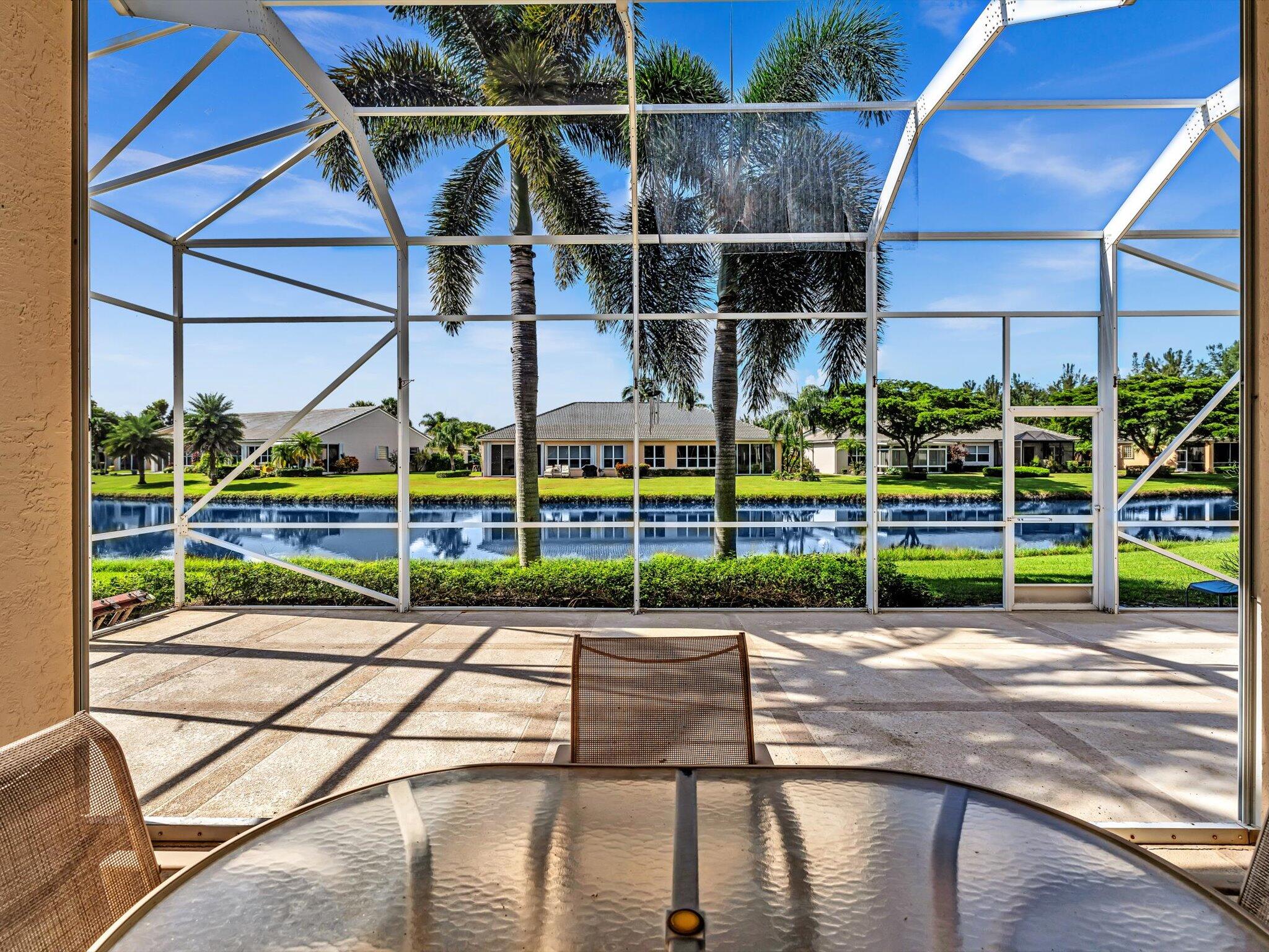 a view of a swimming pool with a yard and sitting area