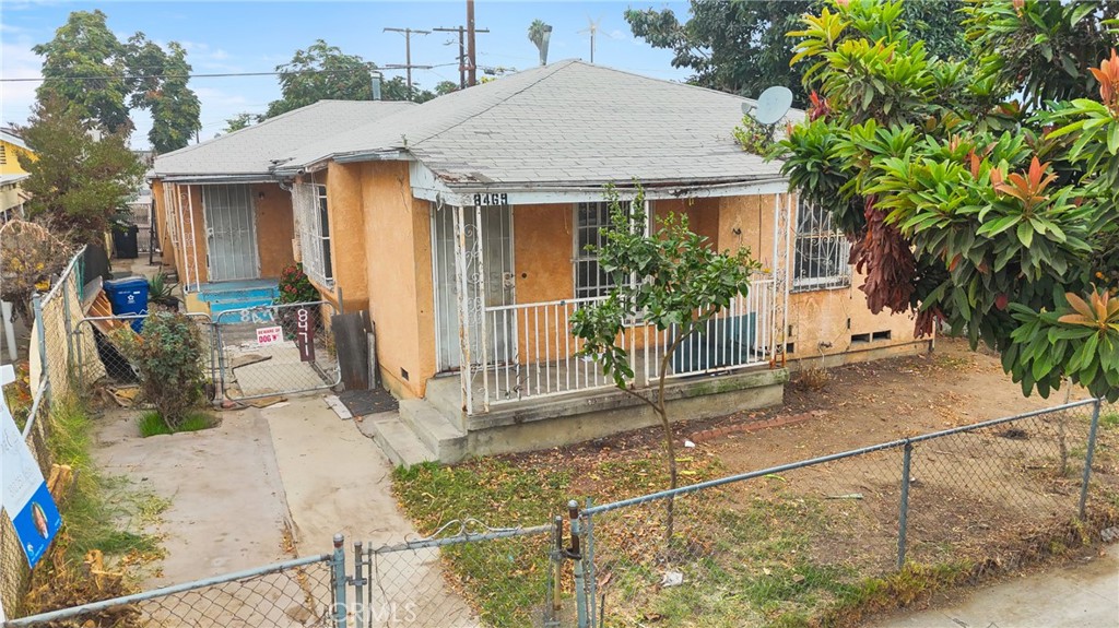 a view of a house with large windows and plants