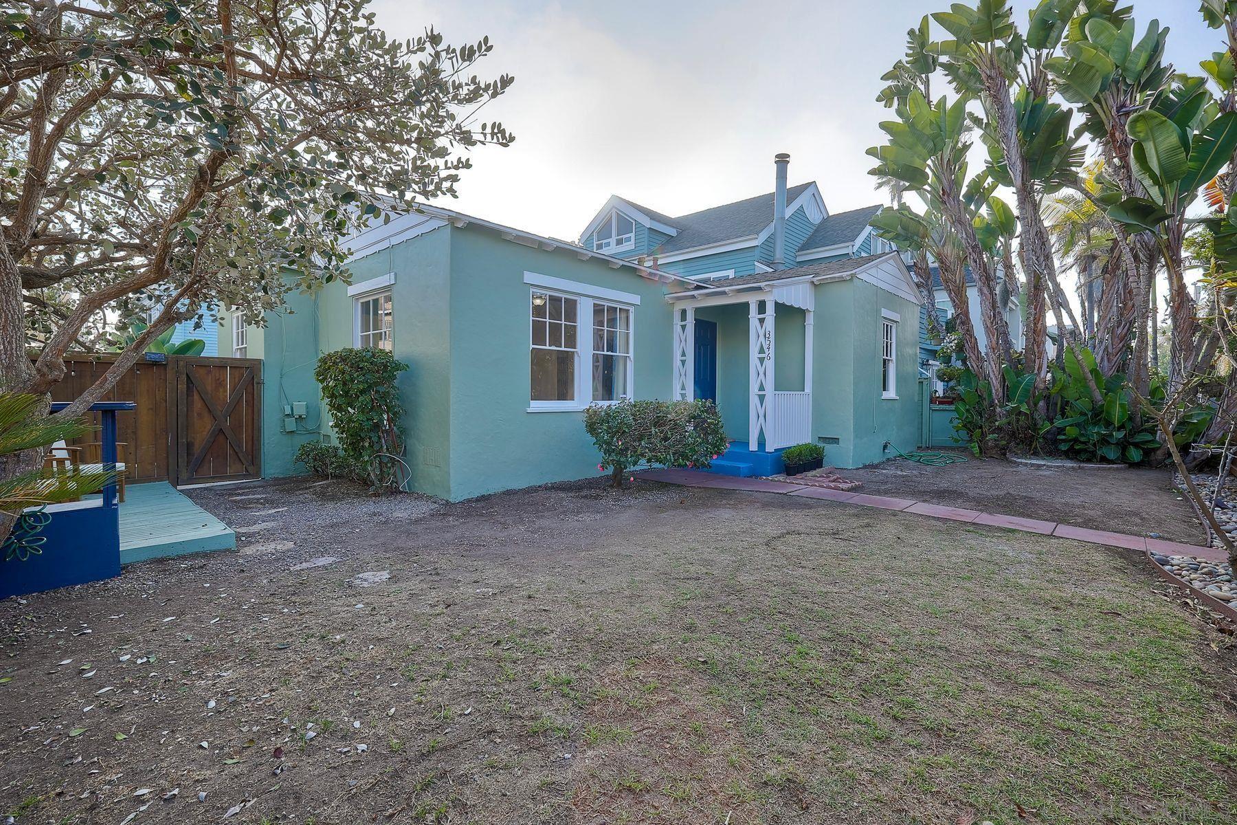 a view of a house with a yard and plants