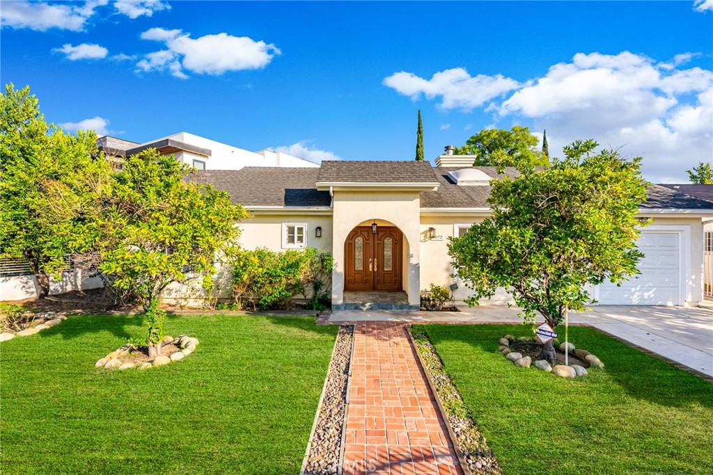 a front view of a house with garden