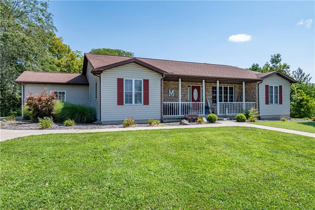 a front view of house with yard and outdoor seating