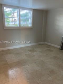 a view of a kitchen with an empty space and a window