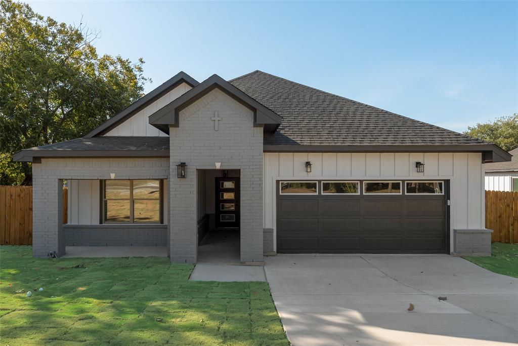 a view of a house with a garage and yard