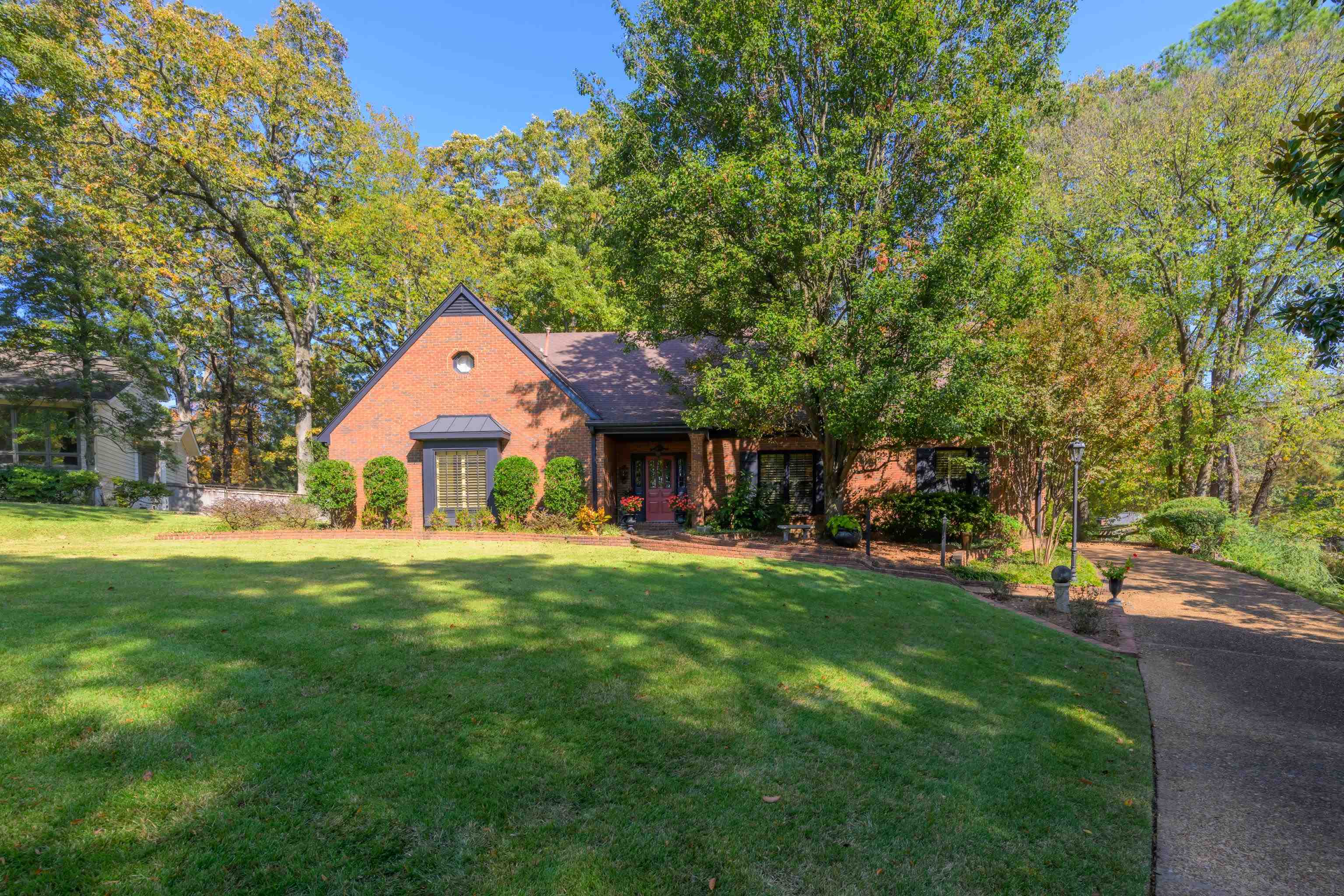 a front view of a house with a garden