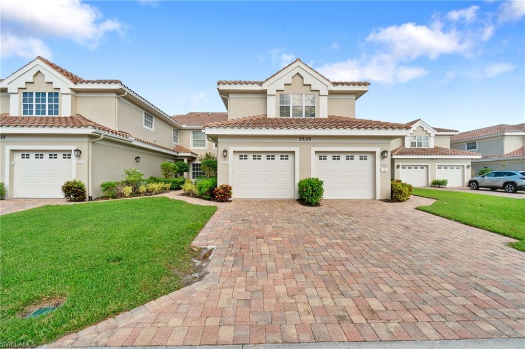 a front view of a house with a yard and garage