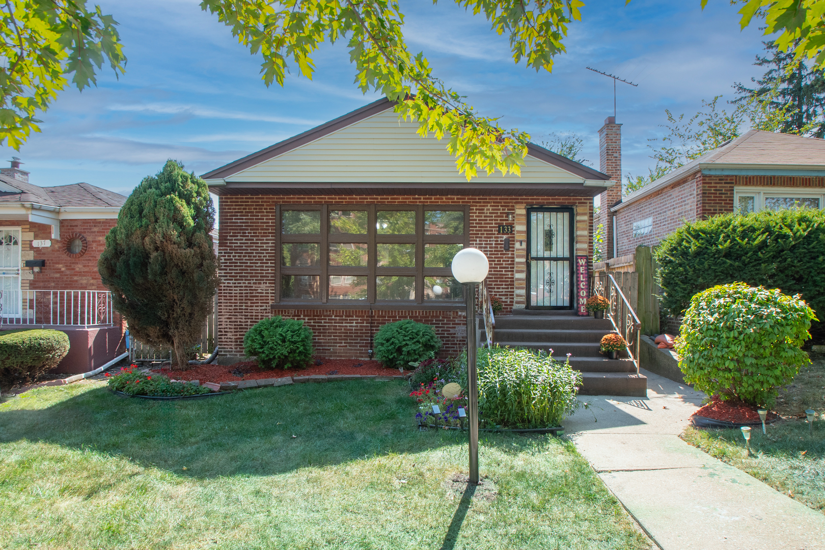 a front view of a house with garden