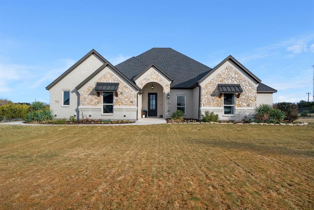 a view of a house with a yard and garage