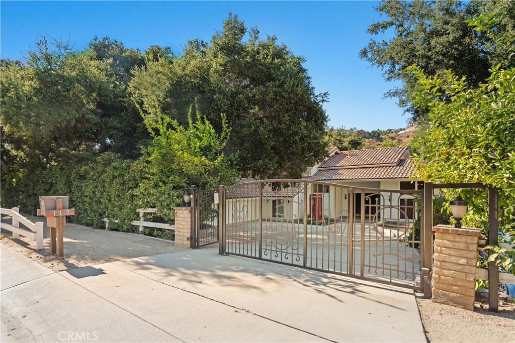 a view of a house with a iron fence