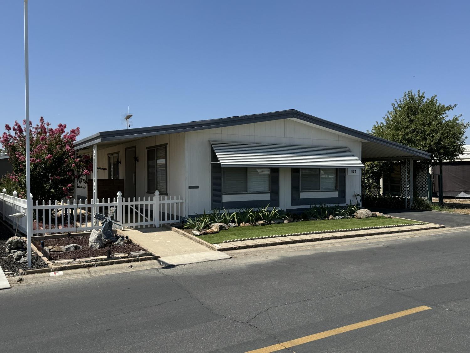 a view of a house with outdoor space and parking